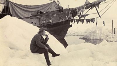 Fridtjof Nansen sits and smokes a pipe in front of 'Fram', Polar Sea, 16th June 1894.